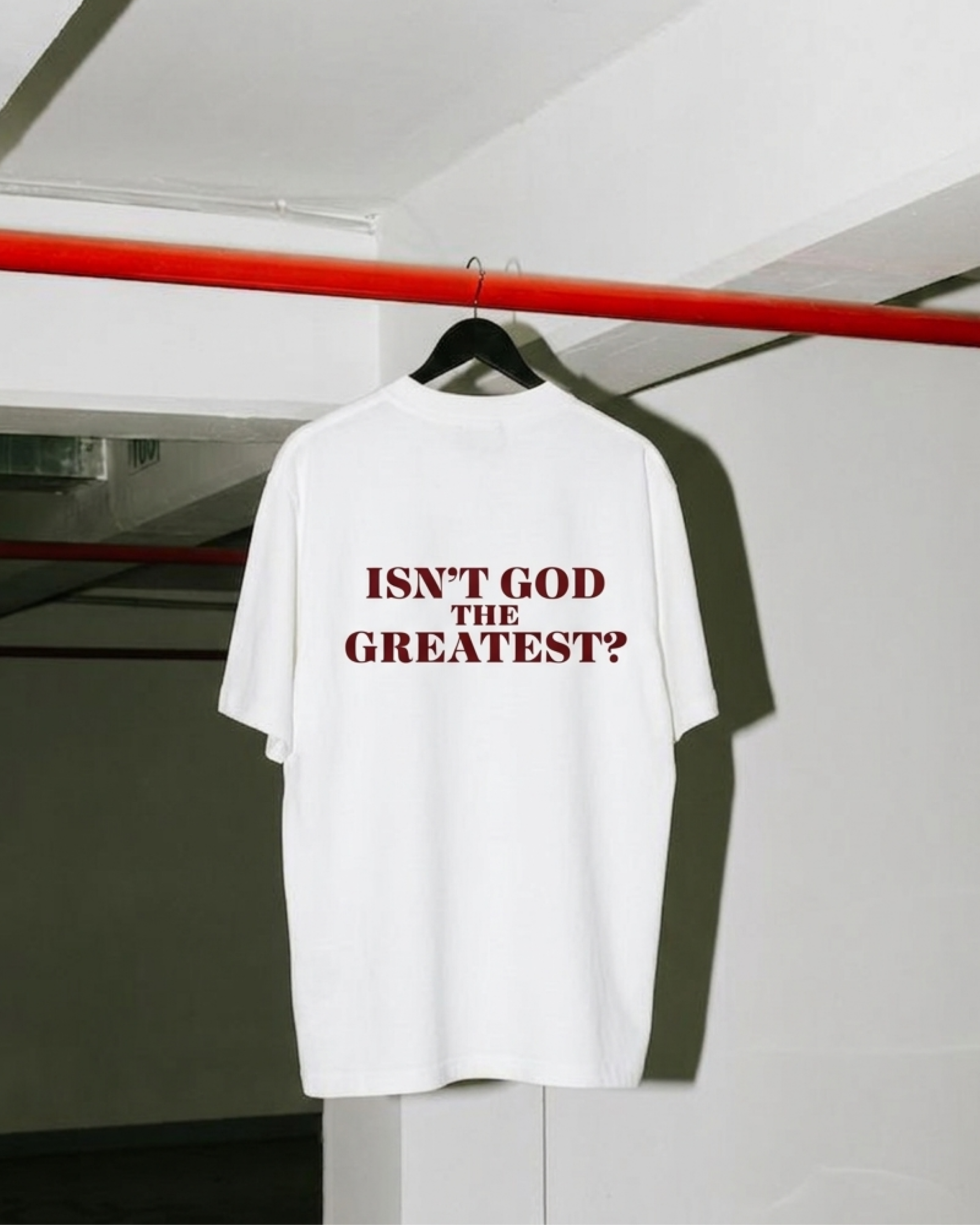 White Isn't God The Greatest graphic tee on a hanger